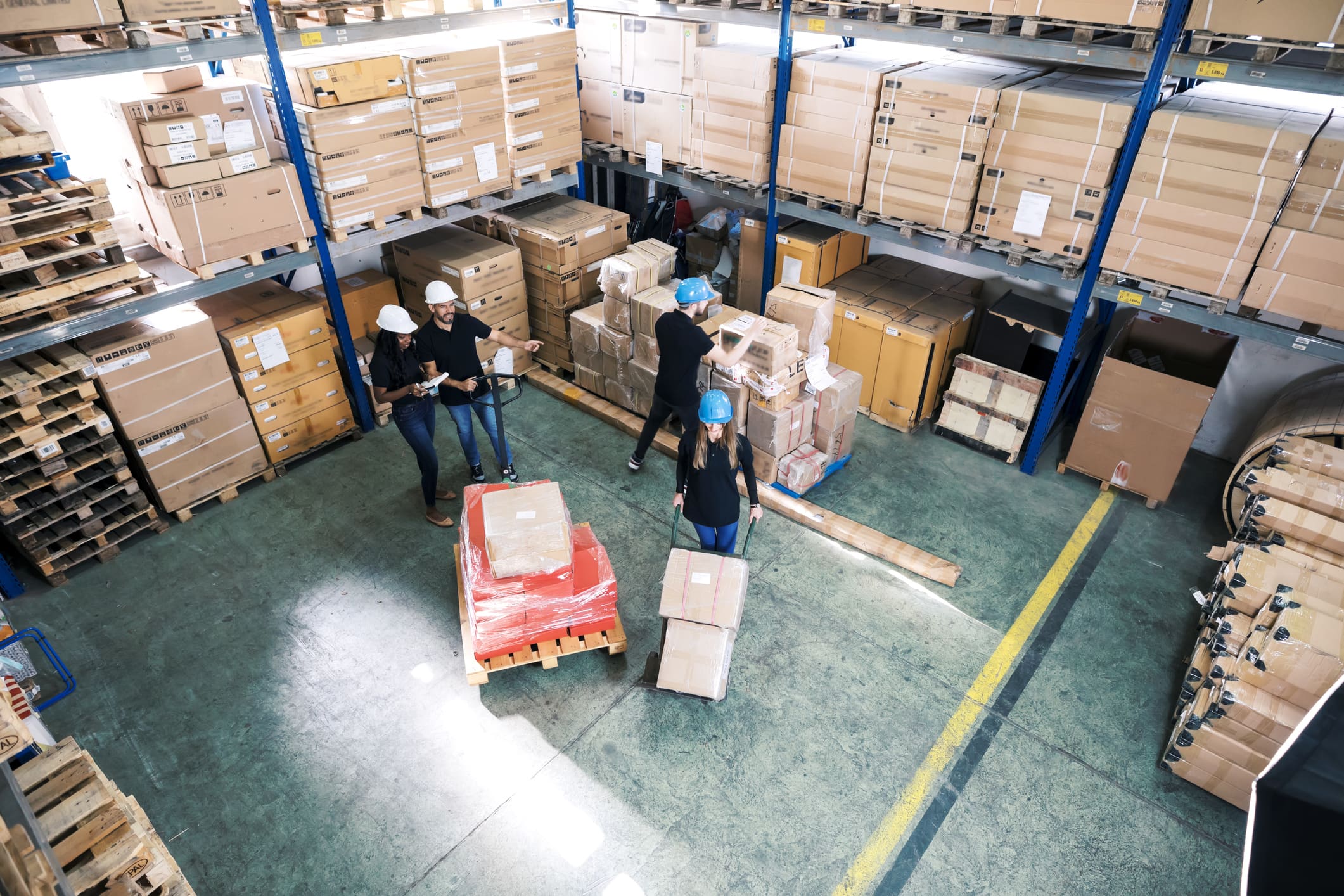 Warehouse workers organizing boxes and pallets.