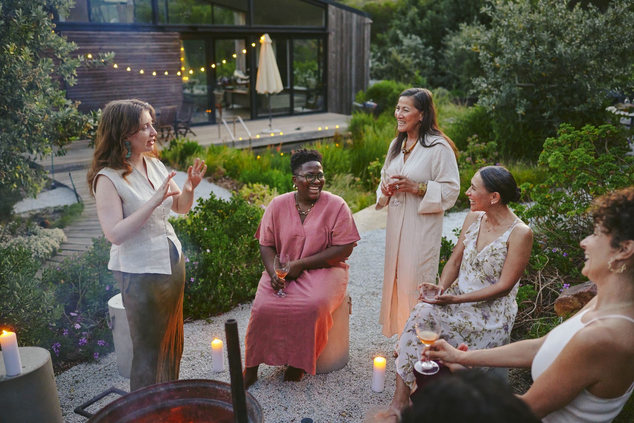 Group enjoying outdoor gathering with drinks.