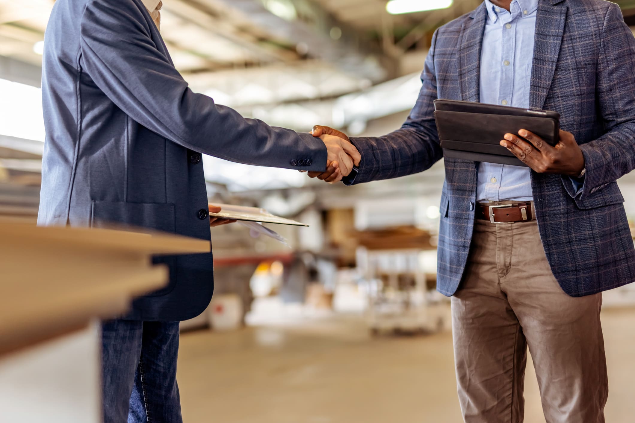 Two businessmen shaking hands in office.