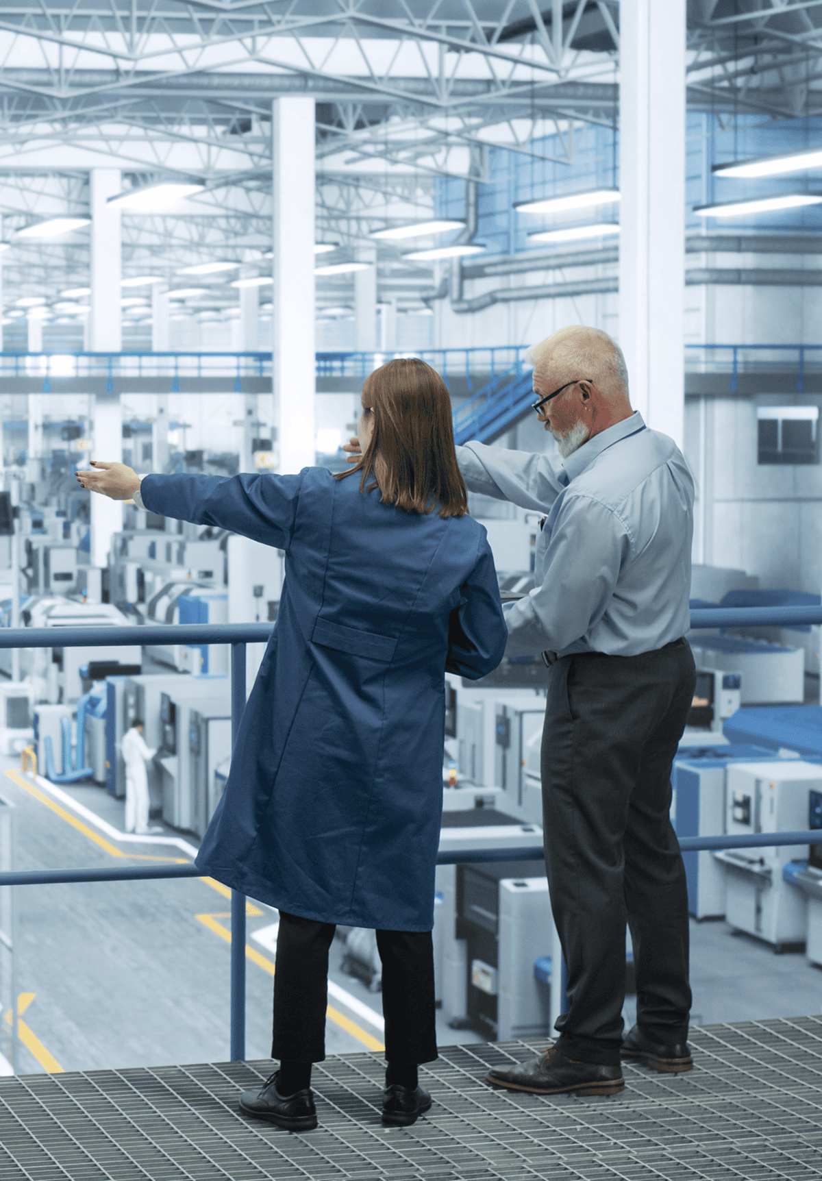 Factory workers observing machinery operations