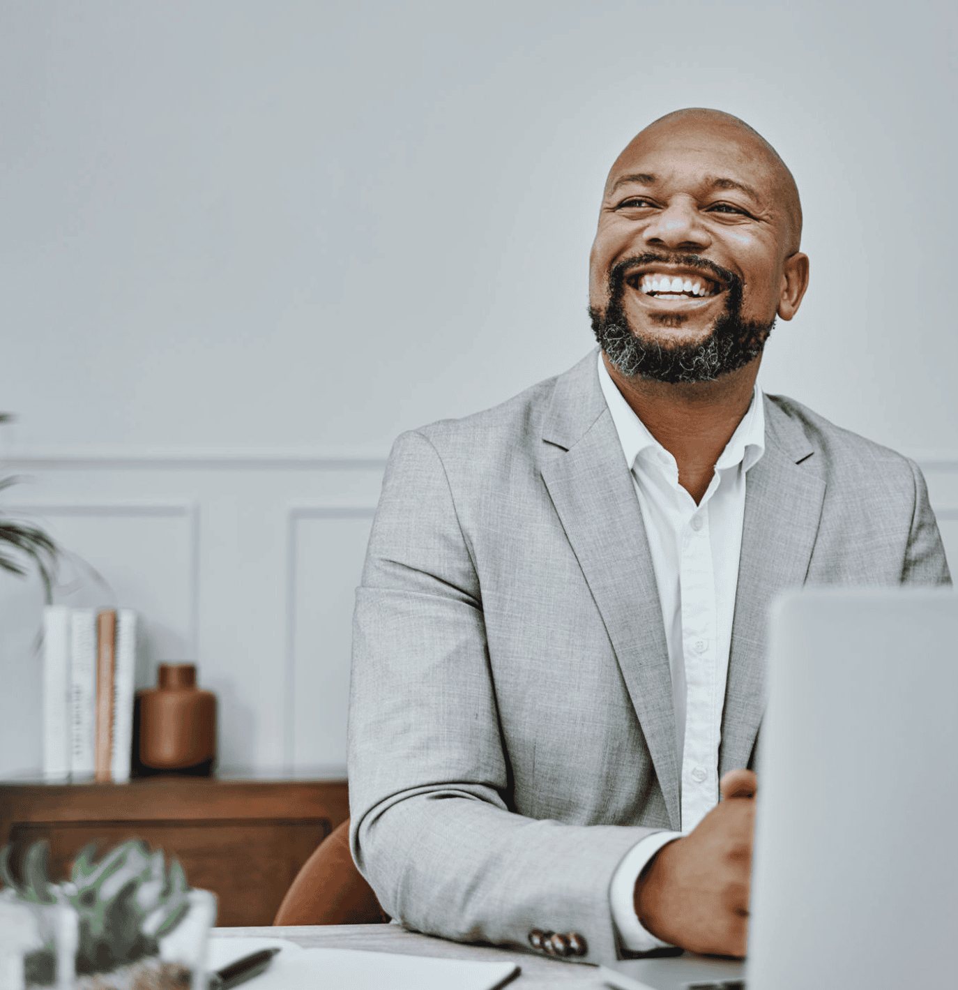 Happy businessman sitting at desk