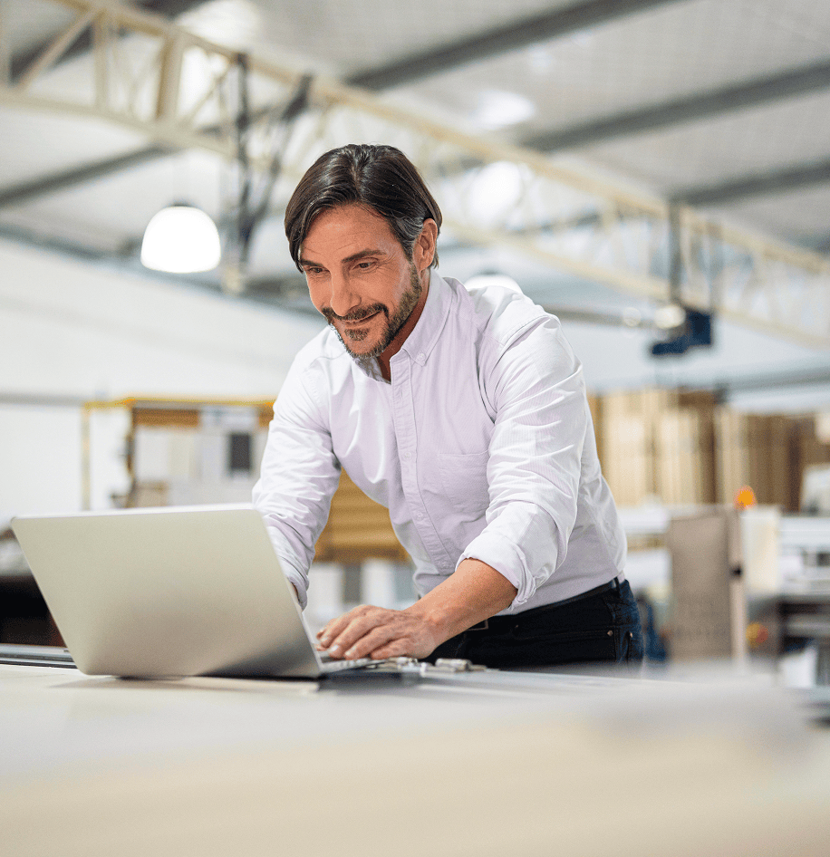Man working on laptop in warehouse